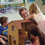 headstart worker playing with children