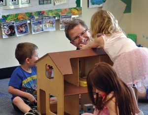 headstart worker playing with children