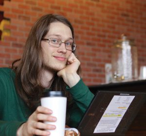 take online classes virtually anywhere, a student in a coffee shop on a computer