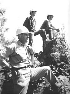 RCC history- loggers posing on cut trees