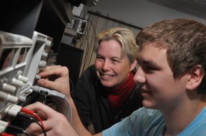Ann Trausch with a Electronics Student