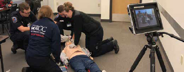 ems students in training with video simulation tools