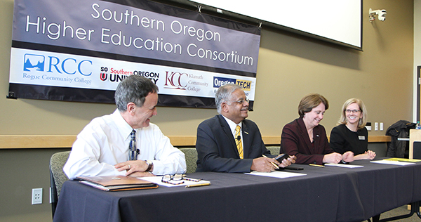 The presidents of Klamath Community College, Oregon Institute of Technology, Southern Oregon University and Rogue Community College share a laugh during a forum announcing the creation of the Southern Oregon Higher Education Consortium.