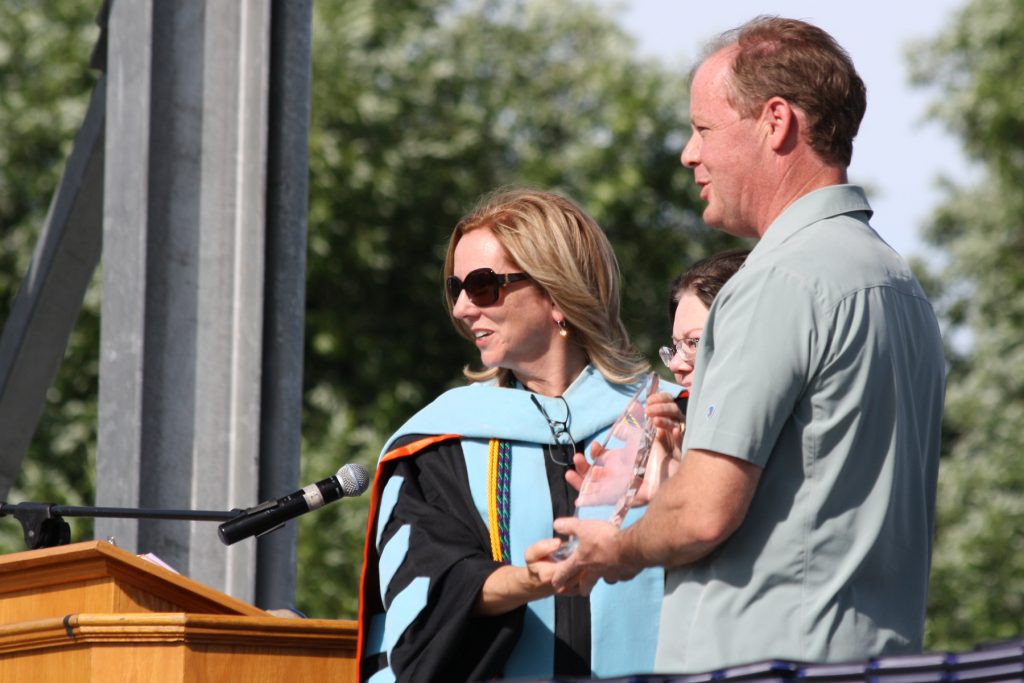 RCC President Cathy Kemper-Pelle presents Scott Chancey with the college's 2019 Outstanding Citizen Award.