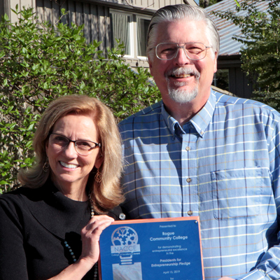 Cathy Kemper-Pelle and Ron Goss accepting the NACCE award