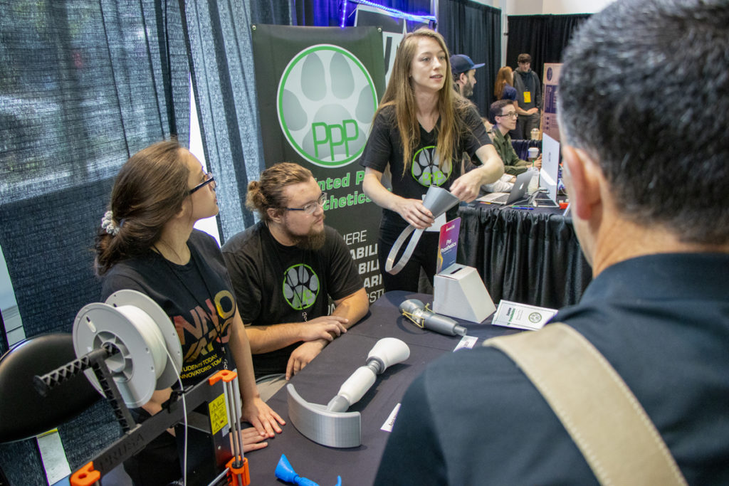 Student innovators from Rogue Community College display their prototype for a pet prosthetic at the 2019 InventOR Innovation Challenge in Portland.