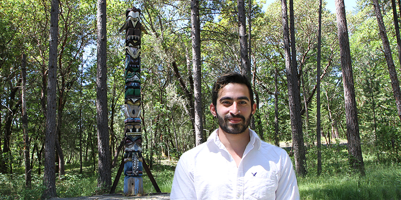 Student worker Alexis Gonzalez Olivo wrote a successful grant application to install a sign at the Redwood Campus totem pole honoring pioneering chain saw artist Don Colp who carved the sculpture in 1990.