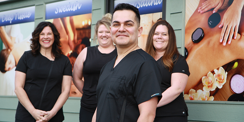 Armando Garcia and his team of licensed massage therapists stand outside River Stone Massage & Wellness in Grants Pass.