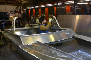 A man welding an aluminum boat