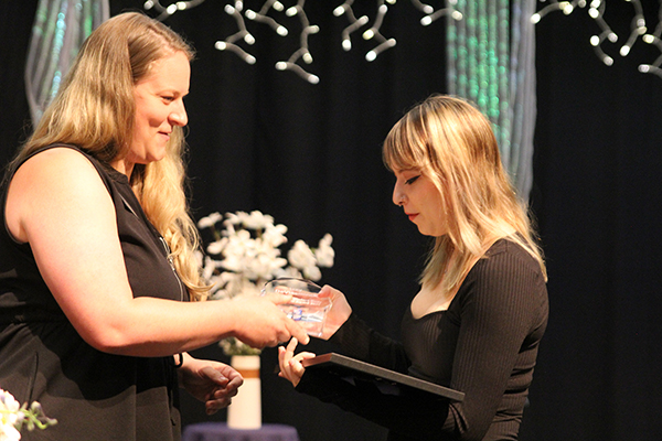 Outgoing ASG President Isabella DeVlaeminck, right, receives an award from ASG Faculty Advisor Chelsea Daugherty during the 2022 RCC Honors Night ceremony.