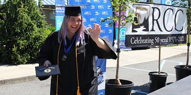 Kelsey Carlson walks across the graduation stage.