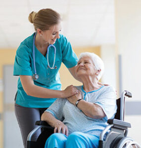 CNA supporting an elder client in a wheel chair
