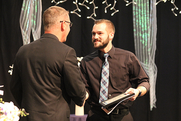 RCC math instructor Doug Gardner shakes hands with Ben Davis, the 2022 Outstanding Student of the Year for Math.