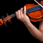 a close up of someone playing the violin