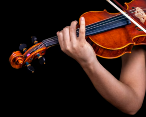 a close up of someone playing the violin